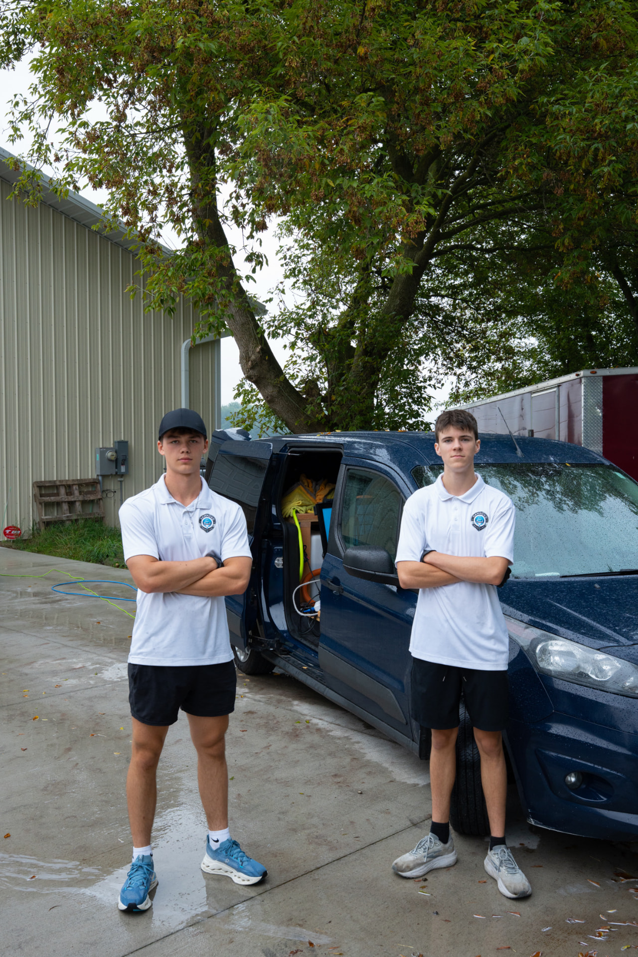 Hammond Detailing crew standing beside their mobile detailing van