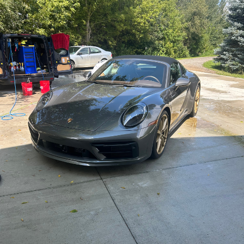 Grey Porsche 911 Targa detailed next to the mobile detailing van