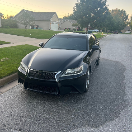 Black Lexus GS F Sport detailed and glossy in a neighborhood driveway