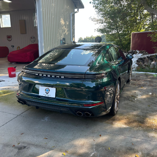 Rear view of a green Porsche Panamera after a full exterior detail